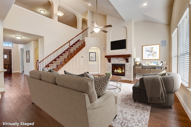 living room featuring ceiling fan, a brick fireplace, high vaulted ceiling, and a wealth of natural light