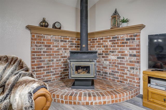 details featuring hardwood / wood-style floors and a wood stove