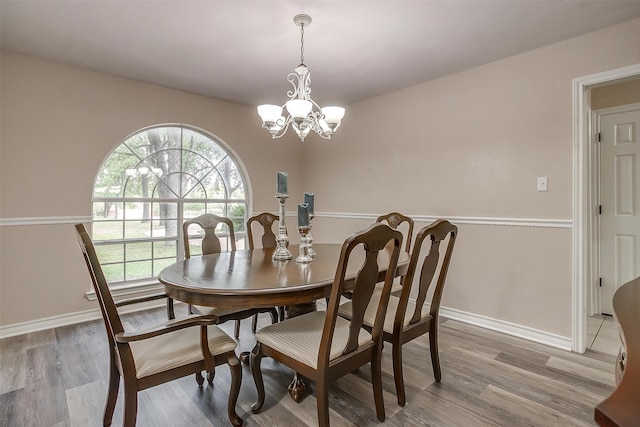 dining space featuring hardwood / wood-style floors and a chandelier