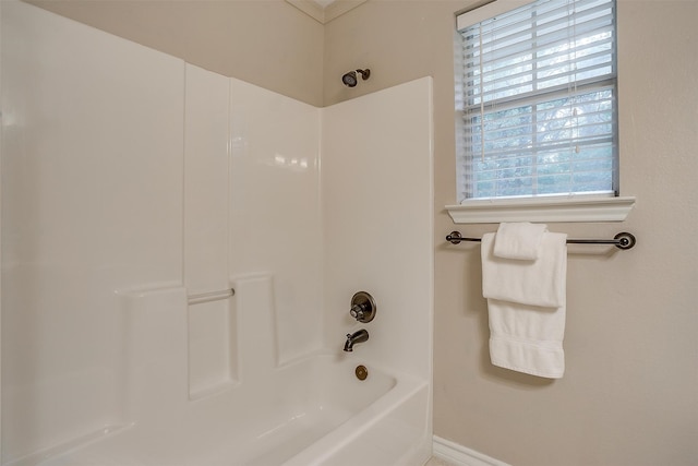 bathroom with a wealth of natural light and tub / shower combination