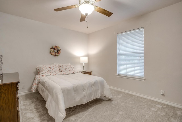 bedroom featuring ceiling fan and light carpet