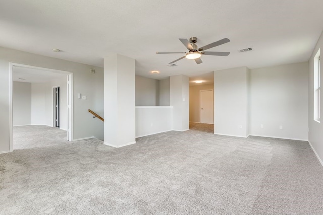 spare room featuring ceiling fan and light colored carpet