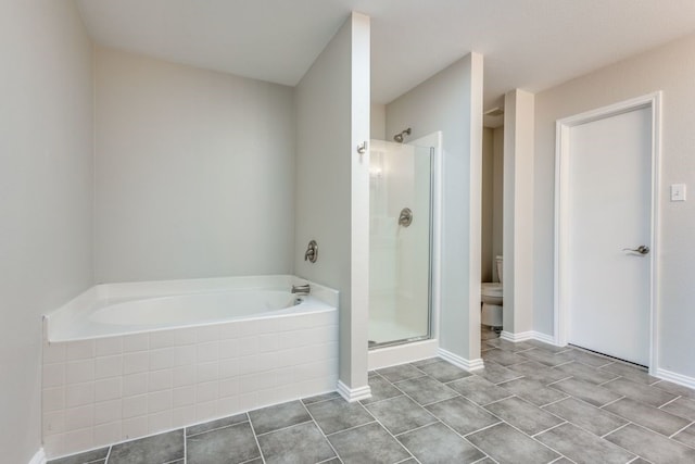 bathroom featuring plus walk in shower, tile patterned flooring, and toilet