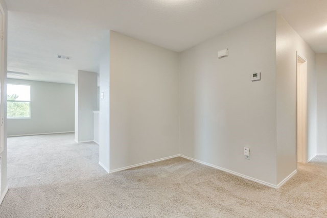 unfurnished room with light colored carpet