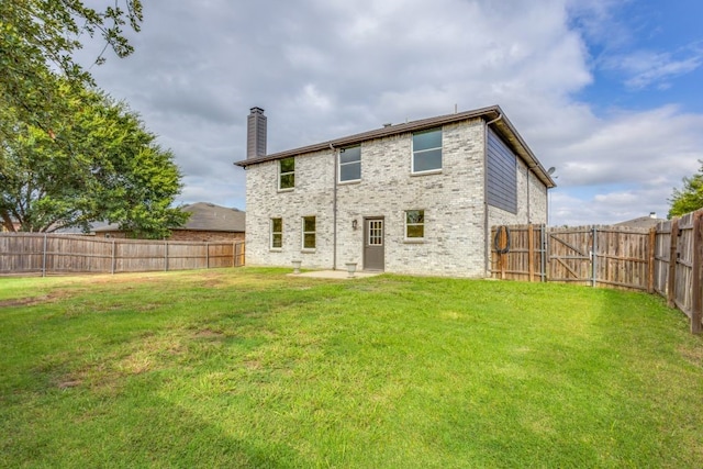 rear view of house featuring a yard