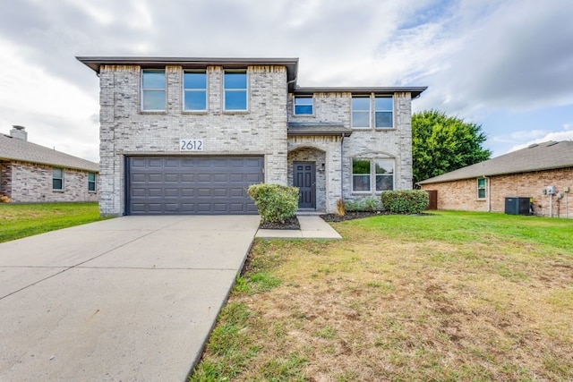 view of front of property with a garage, central AC unit, and a front yard