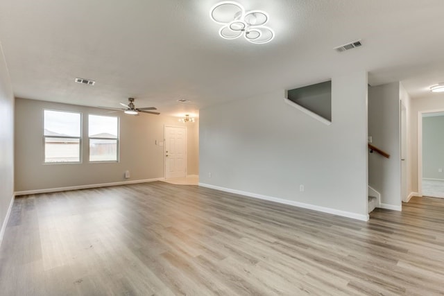 spare room with light wood-type flooring and ceiling fan