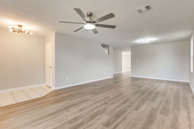 unfurnished room featuring light wood-type flooring and ceiling fan