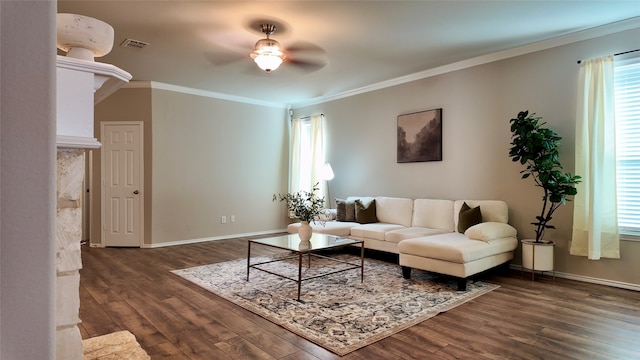 living room featuring ceiling fan, ornamental molding, and dark wood-type flooring