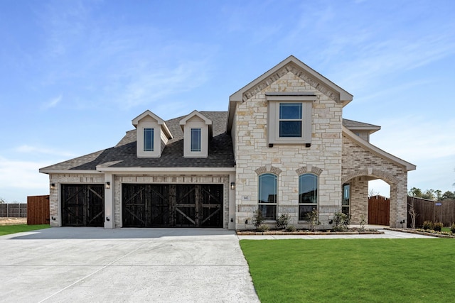 view of front of home with a garage and a front lawn