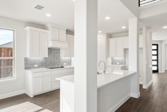 kitchen with white cabinetry, sink, plenty of natural light, and black electric cooktop