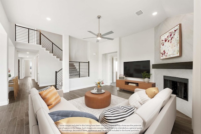 living room with dark hardwood / wood-style floors and ceiling fan