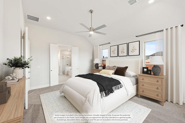 bedroom with light carpet, vaulted ceiling, ceiling fan, and ensuite bathroom