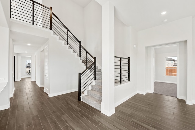 foyer with dark hardwood / wood-style floors and a high ceiling