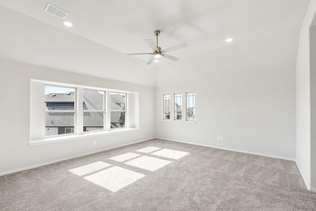 carpeted spare room with ceiling fan and lofted ceiling