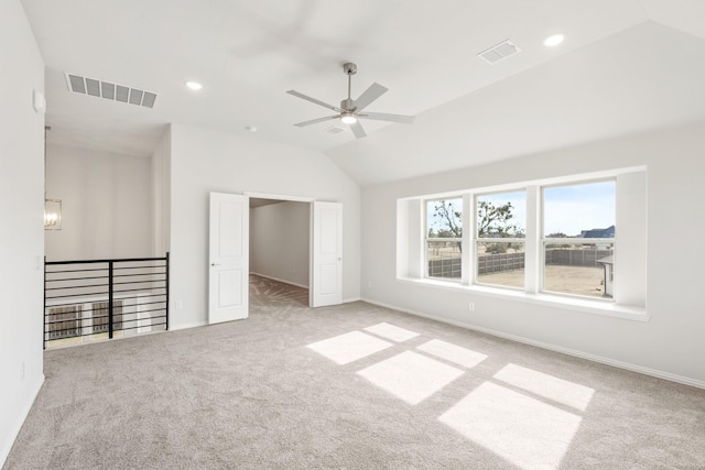 unfurnished bedroom featuring ceiling fan with notable chandelier, lofted ceiling, and light colored carpet