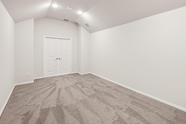 spare room with lofted ceiling and carpet floors