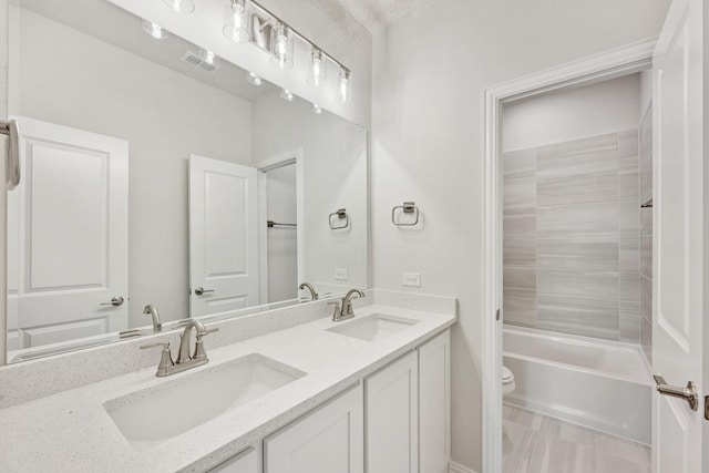 full bathroom featuring vanity, shower / bathtub combination, and toilet