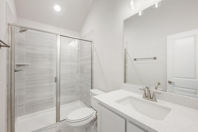 bathroom featuring vanity, an enclosed shower, and toilet