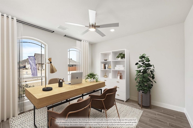 home office featuring wood-type flooring and ceiling fan