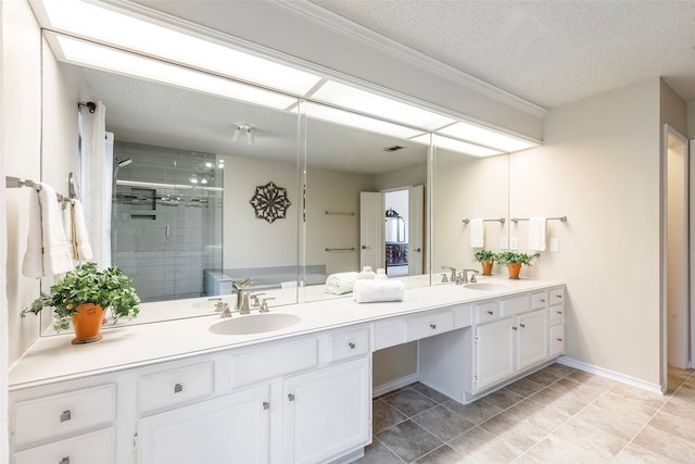 bathroom featuring vanity, a textured ceiling, tile patterned flooring, and an enclosed shower