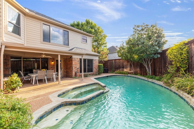 view of swimming pool with an in ground hot tub, ceiling fan, and a patio