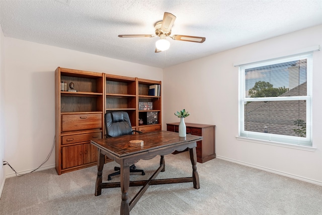 office space featuring ceiling fan, a textured ceiling, and light colored carpet