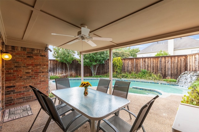 view of patio / terrace featuring ceiling fan and a fenced in pool