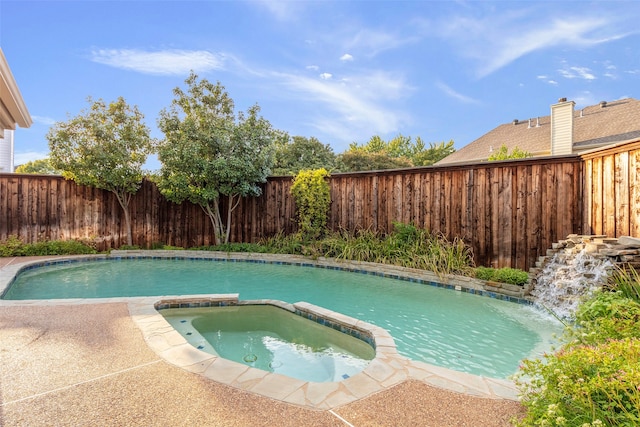 view of swimming pool with an in ground hot tub