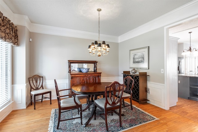 dining room with a wealth of natural light, a chandelier, and light wood-type flooring