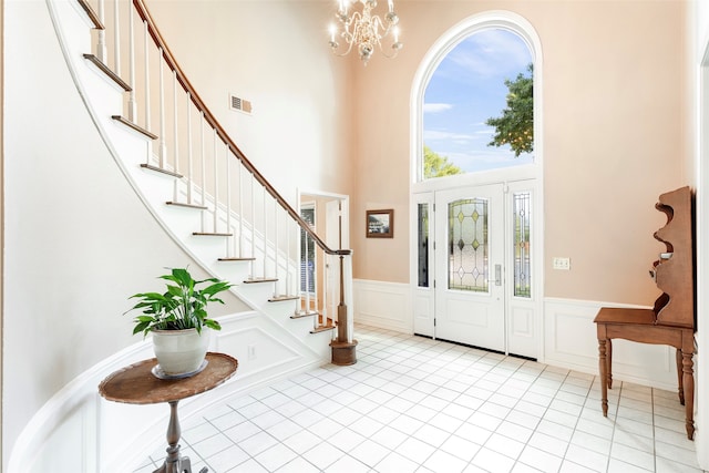 foyer with a high ceiling and an inviting chandelier