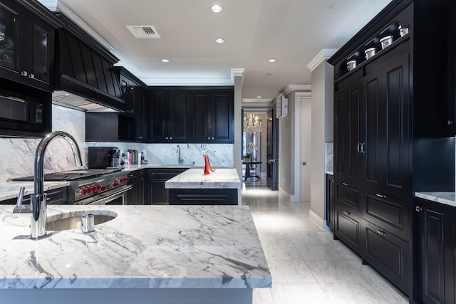 kitchen with backsplash, a kitchen island, light stone countertops, ornamental molding, and sink