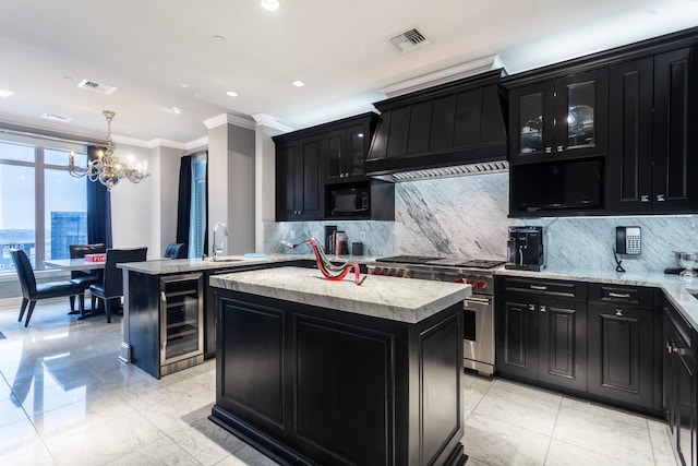 kitchen with hanging light fixtures, high end stainless steel range oven, a kitchen island, and a notable chandelier