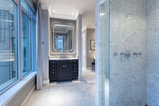 bathroom with a tile shower, a healthy amount of sunlight, vanity, and crown molding