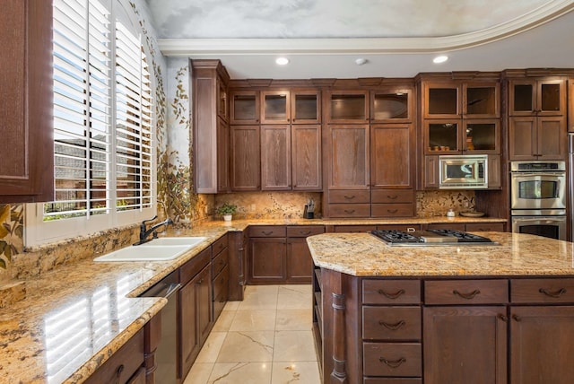 kitchen featuring decorative backsplash, stainless steel appliances, light stone counters, and sink