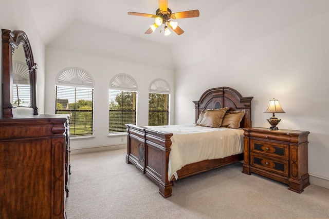 carpeted bedroom with ceiling fan and high vaulted ceiling