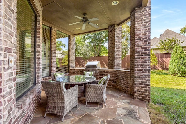 view of patio with area for grilling, ceiling fan, and grilling area