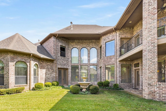 exterior space featuring a yard and french doors