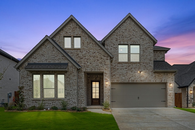 view of front facade with a garage and a yard