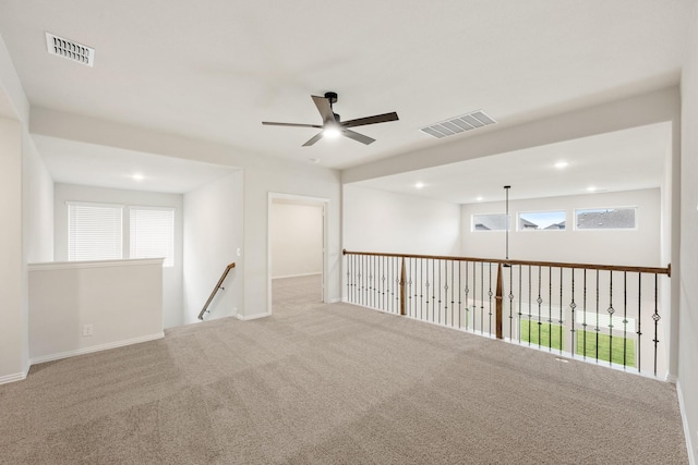 unfurnished room with ceiling fan and light colored carpet