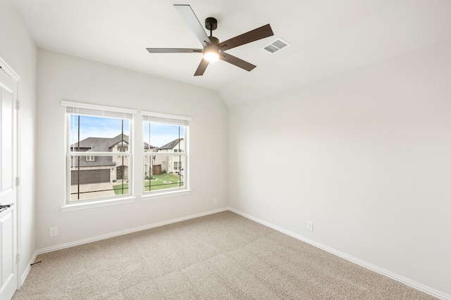 carpeted spare room with ceiling fan and lofted ceiling