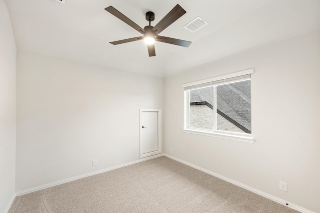 spare room featuring carpet and ceiling fan