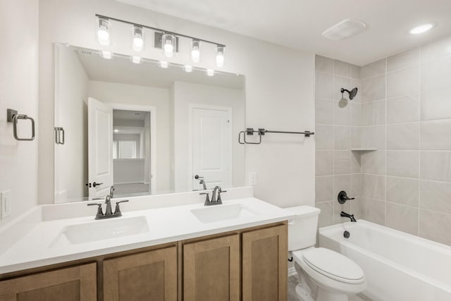 full bathroom with vanity, toilet, and tiled shower / bath combo