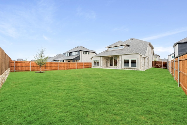 back of house featuring a lawn