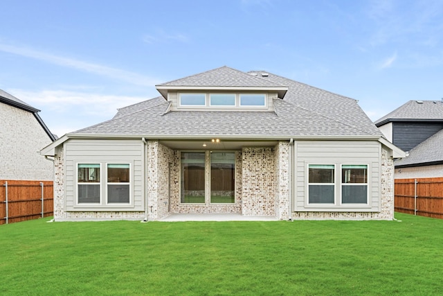 rear view of house with a lawn