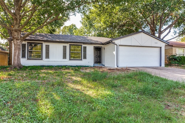 single story home with a front yard and a garage