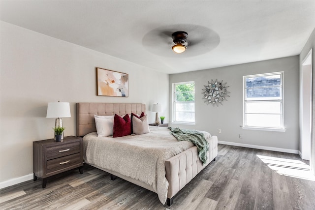 bedroom featuring baseboards, a ceiling fan, and wood finished floors