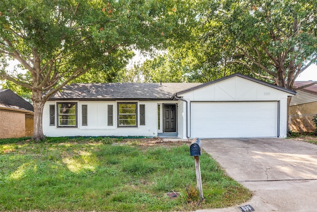 ranch-style home with a front yard and a garage