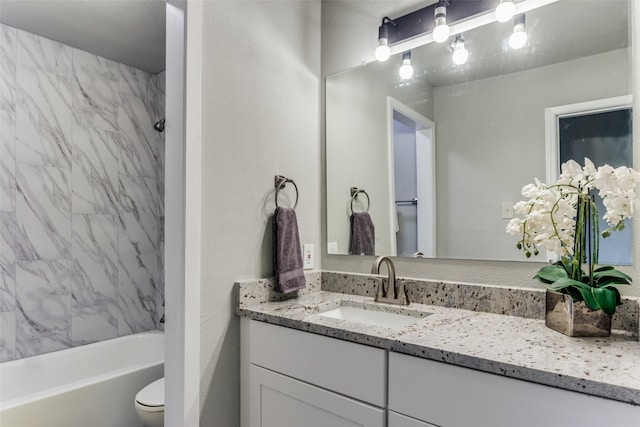 full bathroom with vanity, toilet, and tiled shower / bath