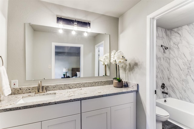 full bath featuring vanity, shower / bath combination, and toilet